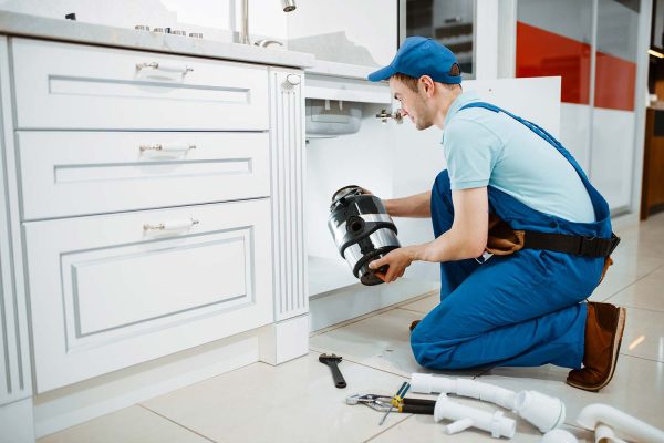 male-plumber-in-uniform-installing-disposer-resize.jpg male-plumber-in-uniform-installing-disposer-resize.jpg